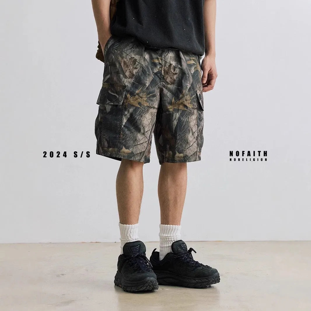 Man wearing loose straight-leg denim shorts in army green, showing mid waist and casual style.