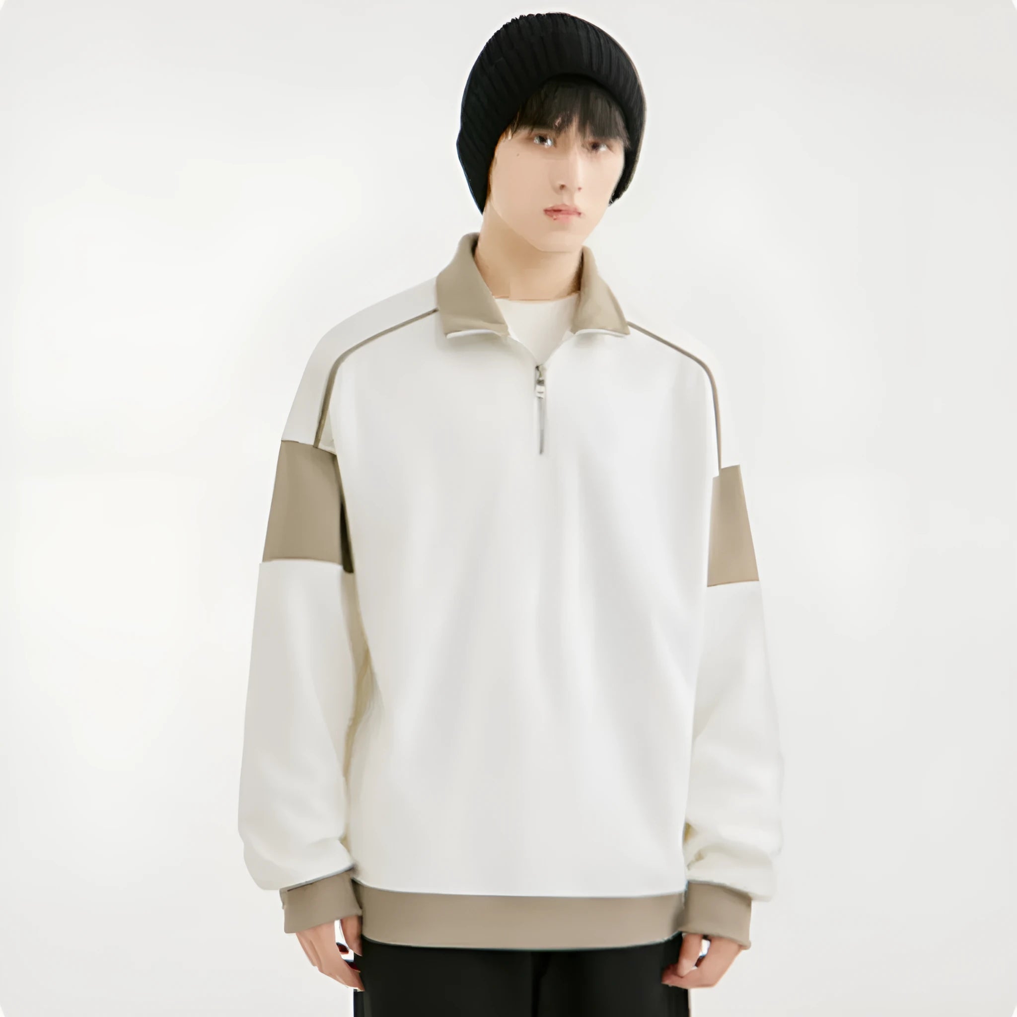 A man's thin corduroy hooded pullover sweater with drop shoulders and loose lapels, in a neutral colour.