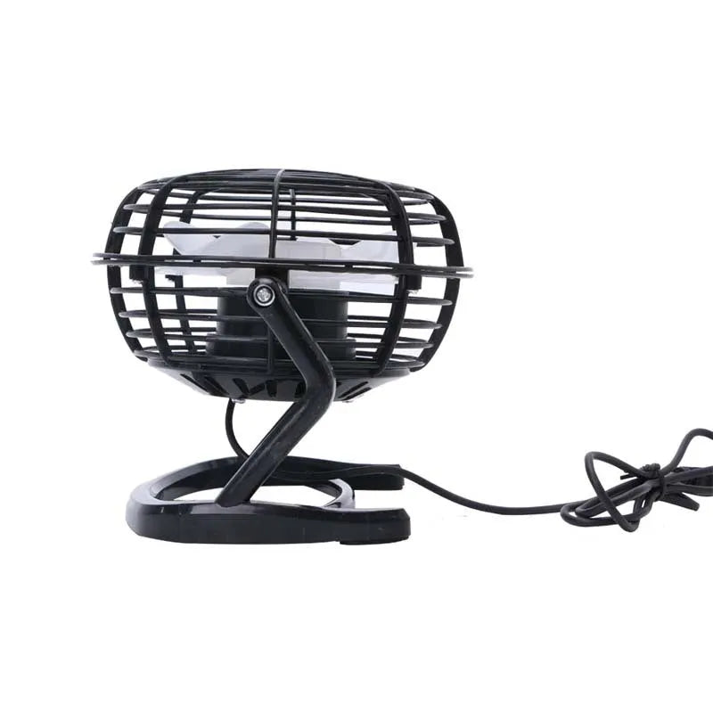 Mini black USB desk fan with adjustable head on a wooden desk next to a laptop.