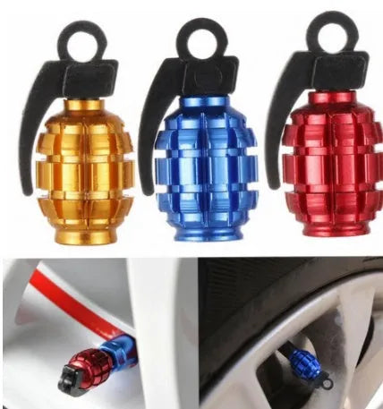 Two car tyre valve caps in blue and gold on a wheel rim
