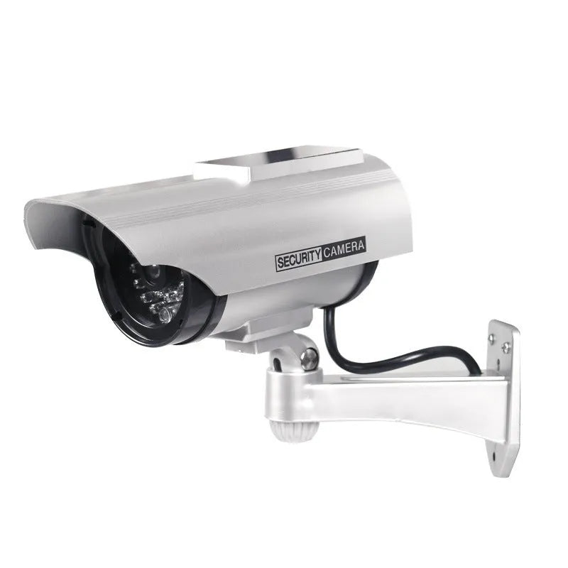 Solar-powered fake security camera in black finish mounted on a wall outdoors