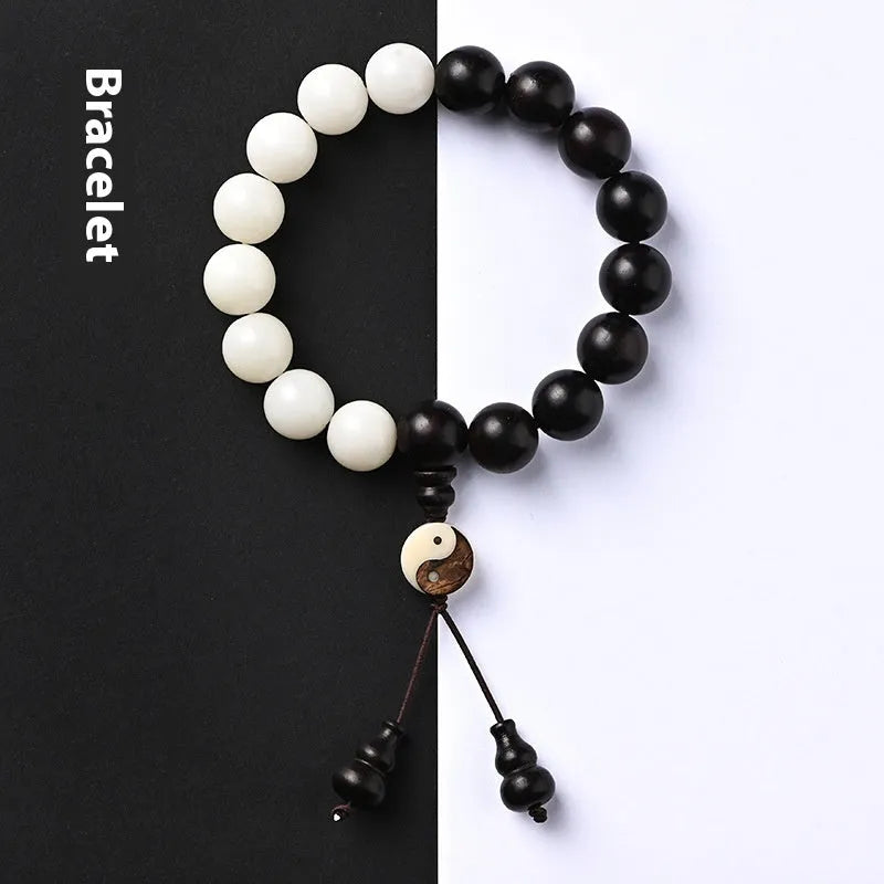 White and black bodhi seed bracelet with eight-diagram pattern, shown as a bracelet and lanyard.