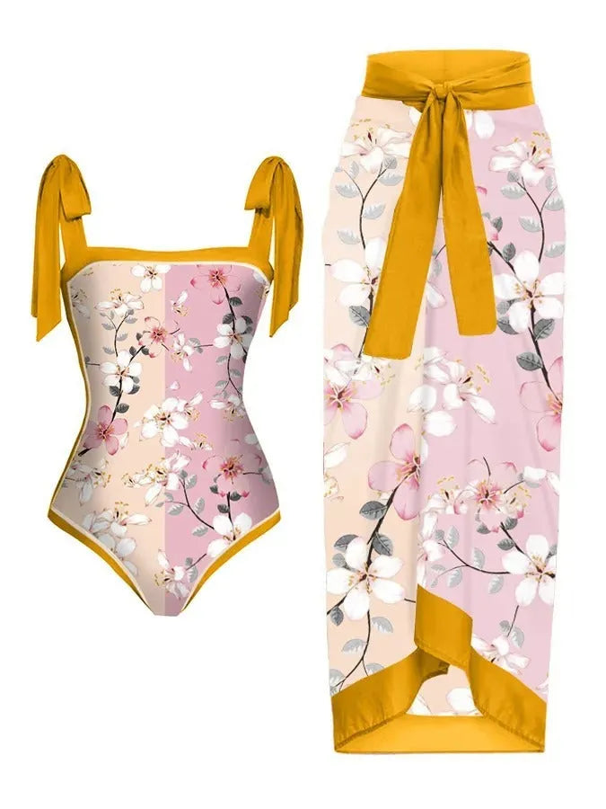 Women's floral print two-piece swimsuit with a sheer chiffon hip skirt, shown in one of the available colour variations.