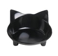White shallow melamine pet bowl with non-slip black rubber base on a wooden floor.