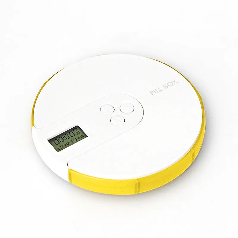 Blue seven-compartment alarm clock pill dispenser with digital display, shown next to pills.