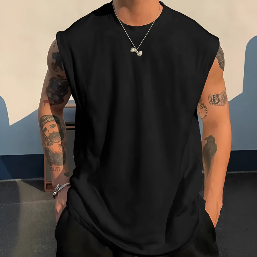 Men's loose-fitting solid colour cotton tank top on a hanger, shown in a light colour.