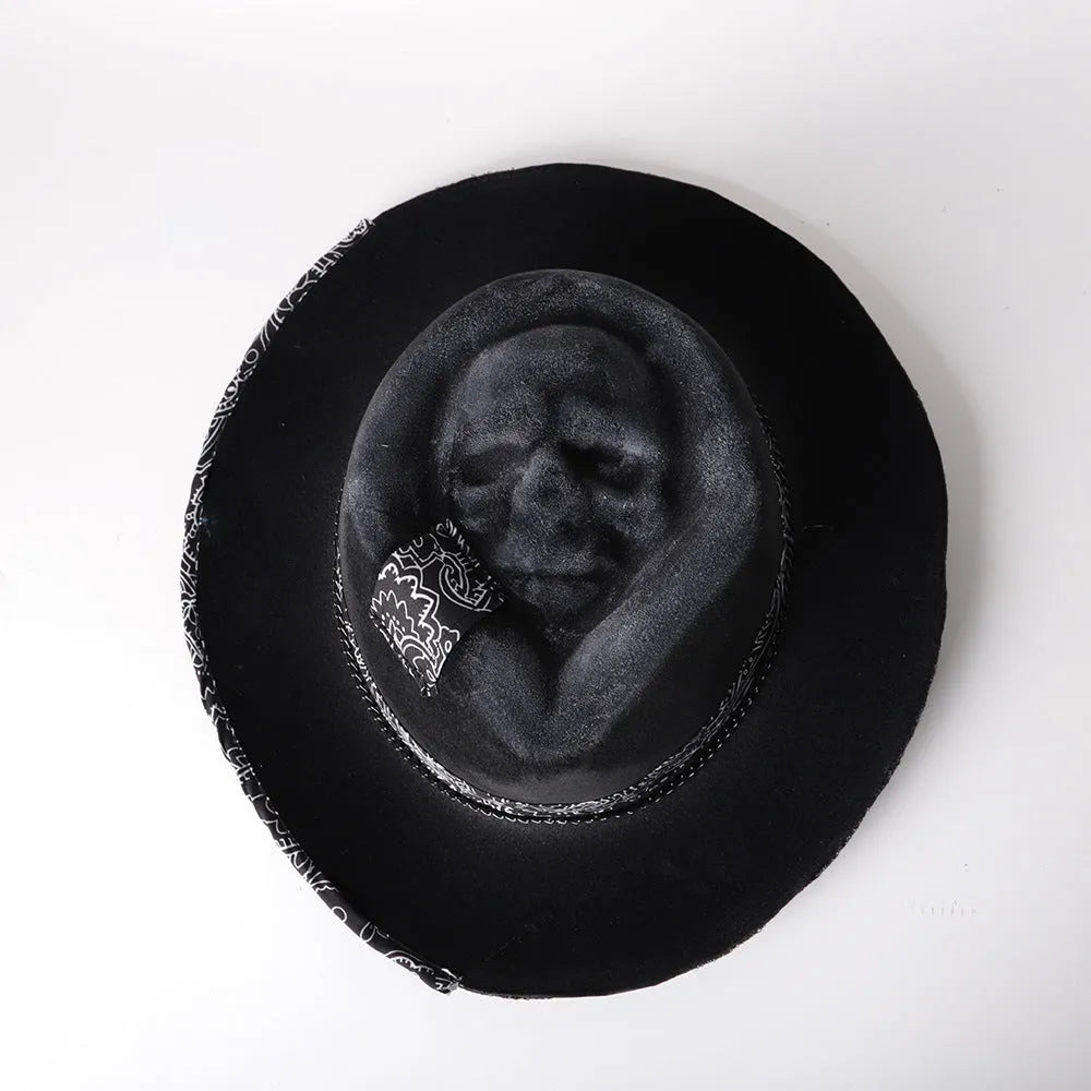 Handmade black skull hat with conical crown, made from wool and denim fabric, on a neutral background.