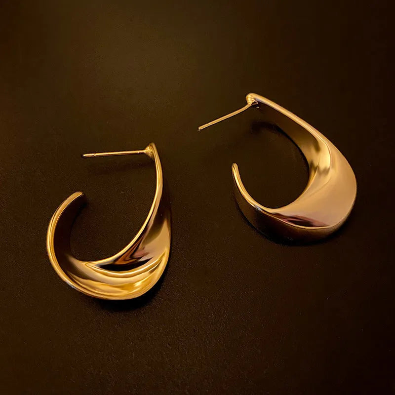 Twisted geometric metal hoop earrings in gold and silver electroplated colour options