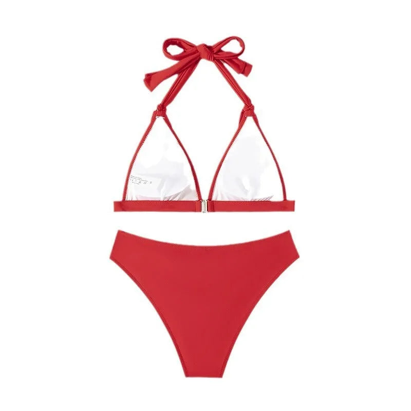 Red women's lace-up halterneck bikini set with matching shorts on mannequin