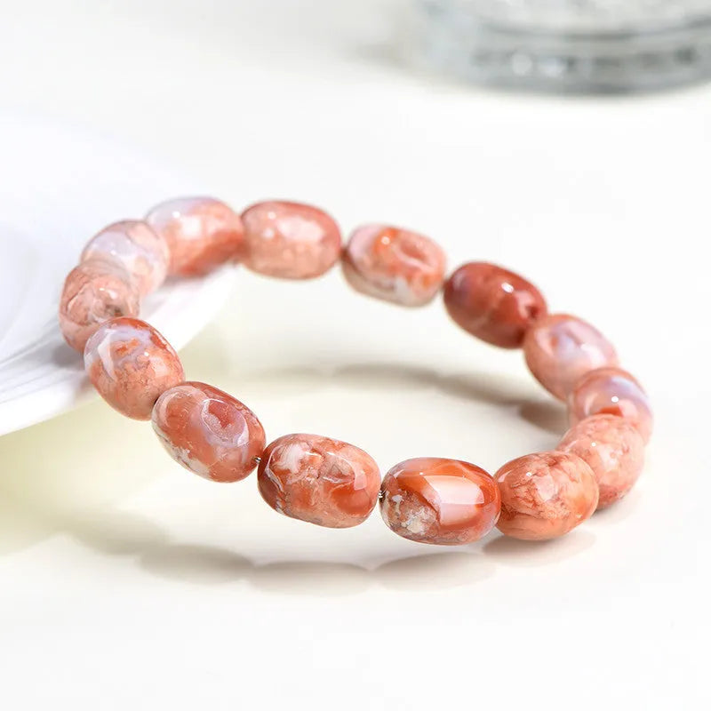 Natural cherry agate barrel bead bracelet with Ruyi decoration on white background