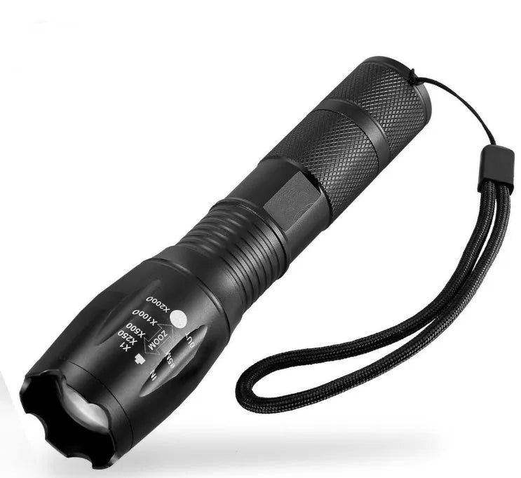 Black aluminium alloy zoomable LED flashlight with adjustable focus ring on a textured body.