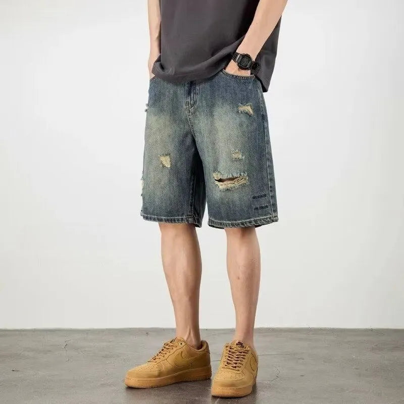 Blue retro loose hole men's denim shorts on a neutral background
