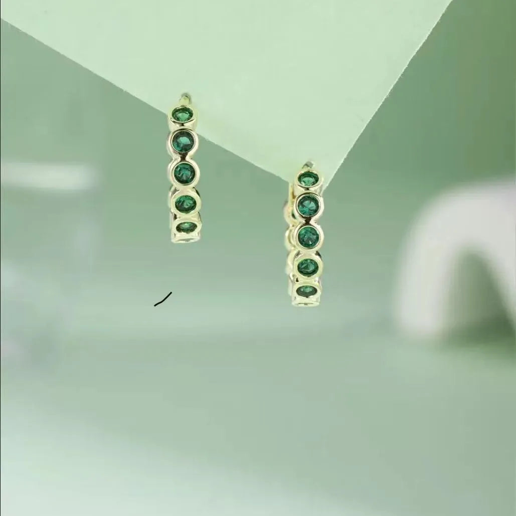 Gold S925 sterling silver geometric stud earrings with inlaid zircon on a white background