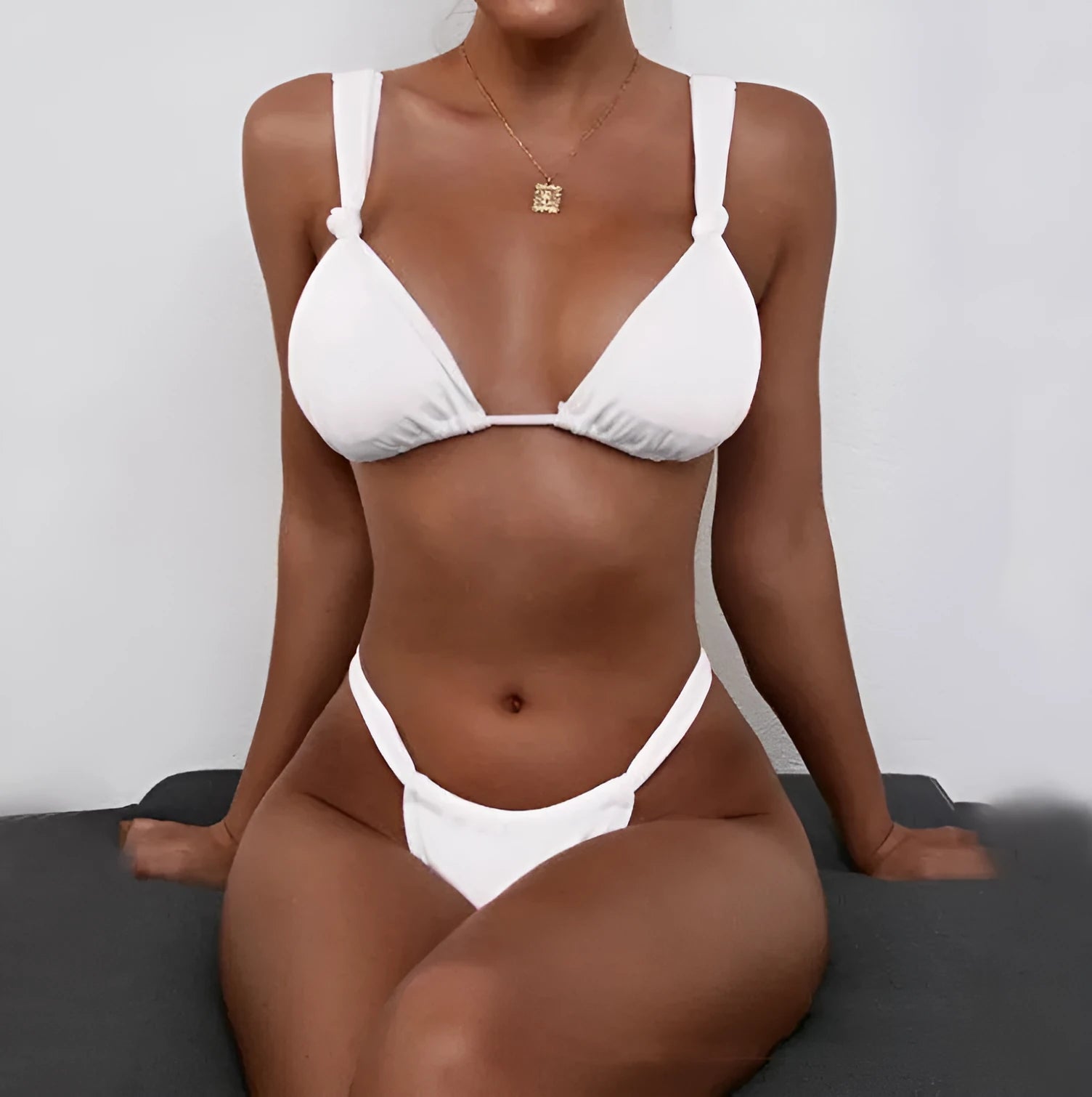 Women's pleated split strap bikini swimsuit in a solid colour with knotted detailing.