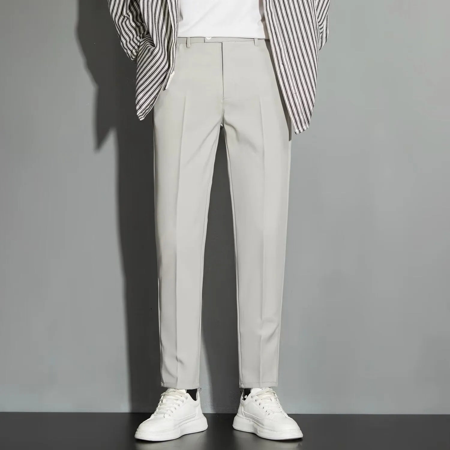 Men's straight leg ankle-length suit trousers in apricot colour on a model