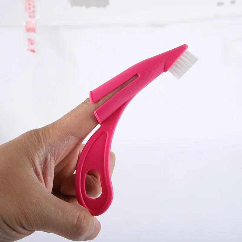Red and white pet finger toothbrush with silicone bristles for cleaning dog and cat teeth.