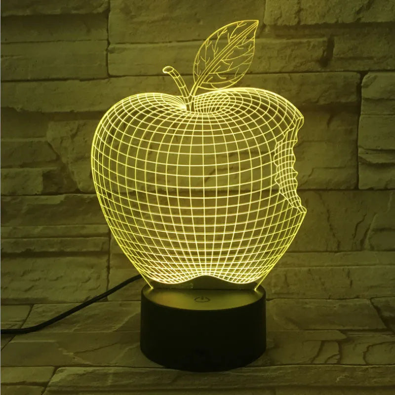 3D fruit-shaped colourful night light with acrylic shade and touch control on a dark surface