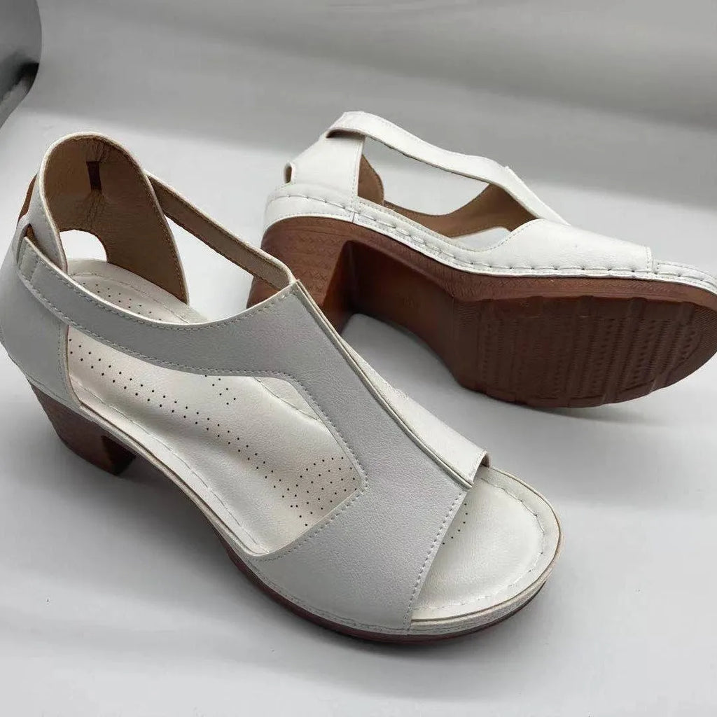 Women's peep toe wedge sandals with buckle detail, low heel, on a white background.