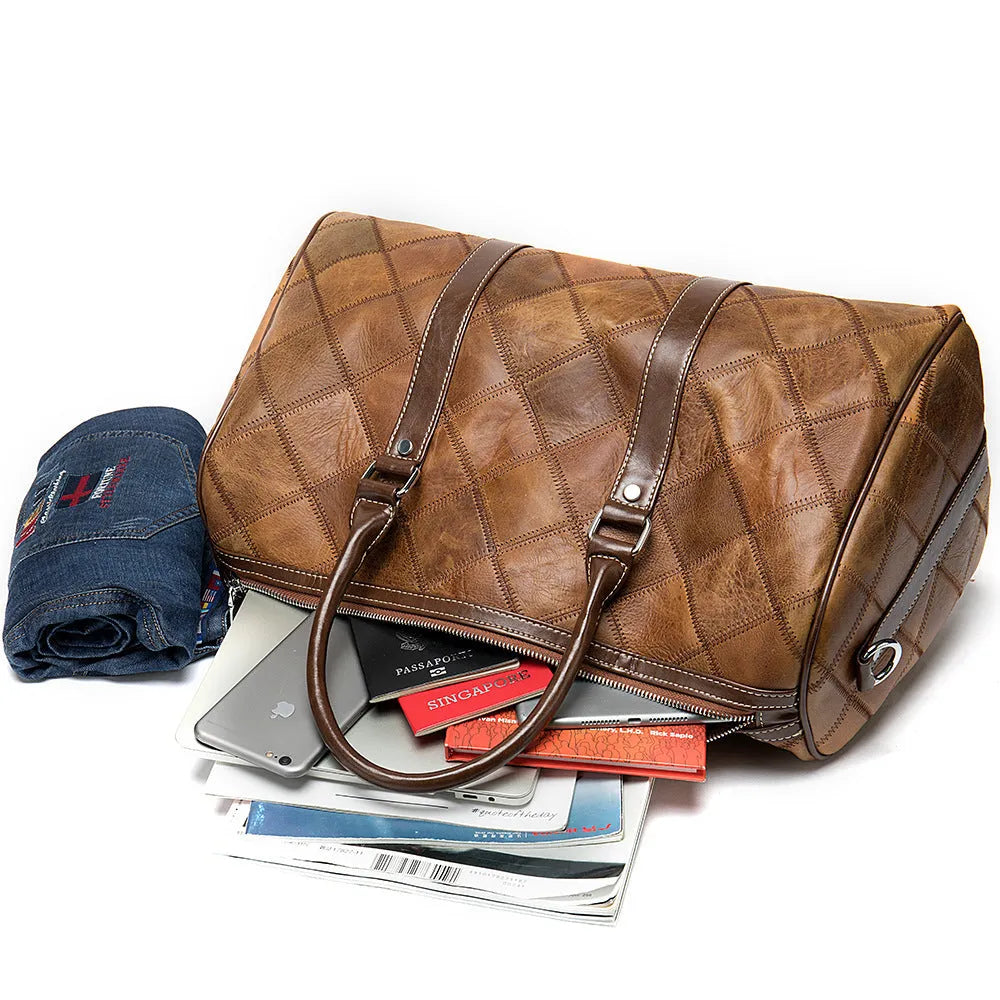 Men's vintage leather duffel bag in black showing internal phone and ID pockets.