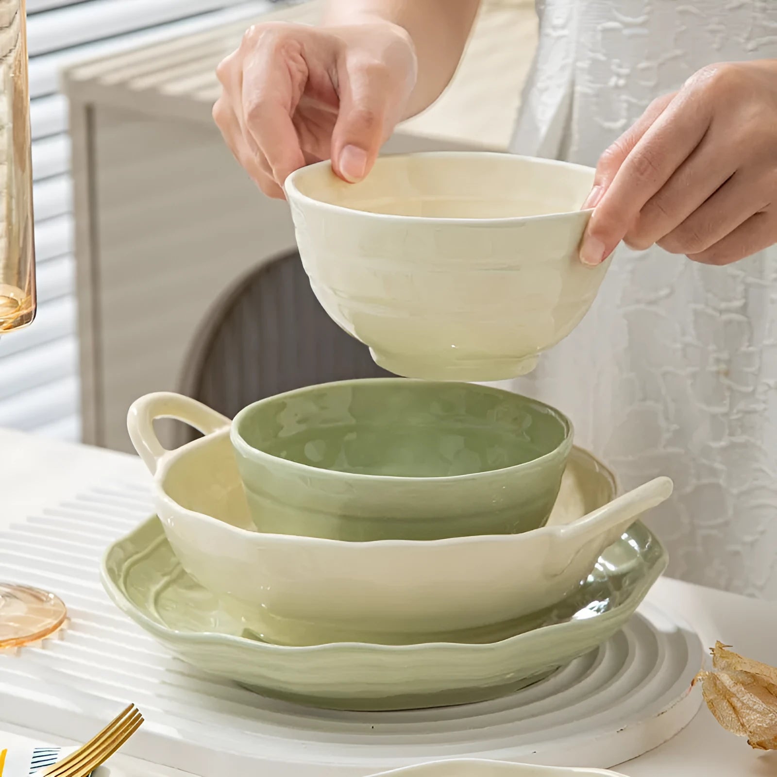 Seven-piece solid colour ceramic tableware set with modern Japanese style design on a table.