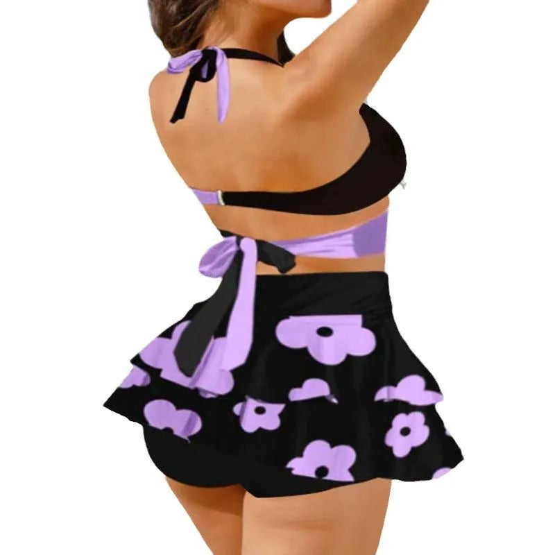 Women's purple bikini set with matching skirt showing lace-up detailing and high-waist styling