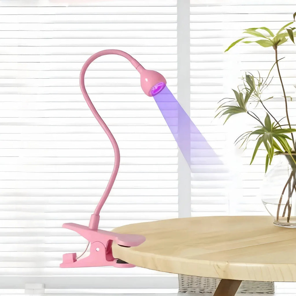 Goose neck nail lamp with USB clip, 395nm purple light curing UV glue on nails in a home manicure setting.