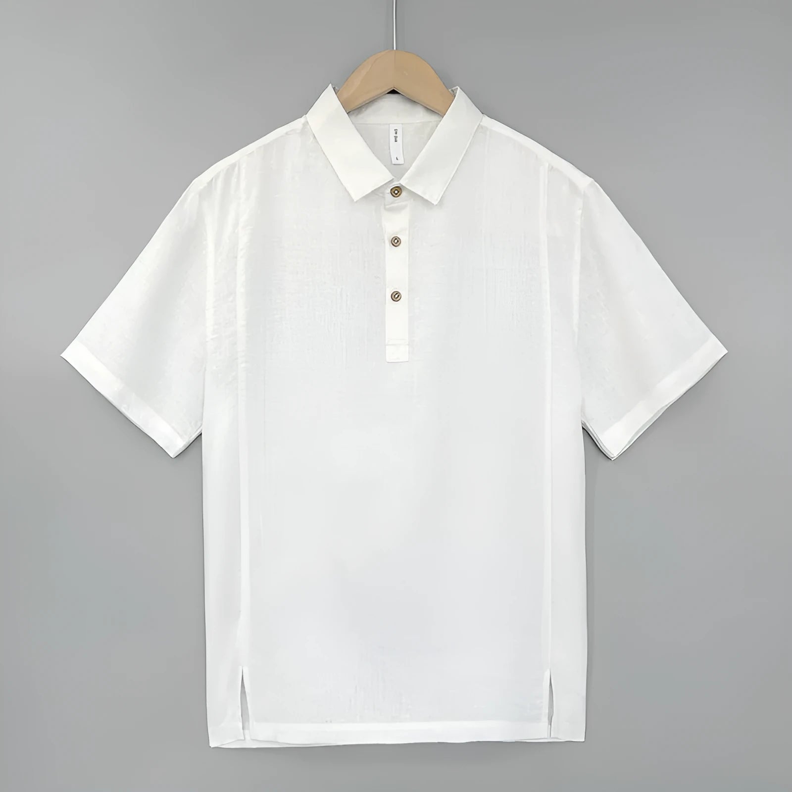 Men's loose fit linen summer top with short sleeves and thin lapels on a hanger.