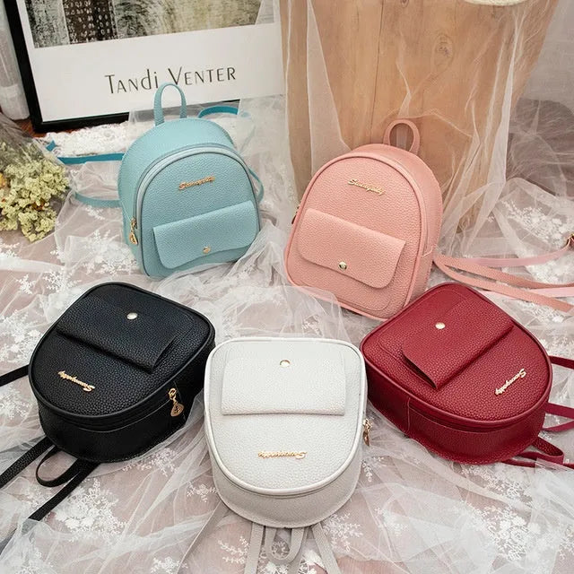 Women's compact black PU bag worn as both a shoulder bag and a small backpack.
