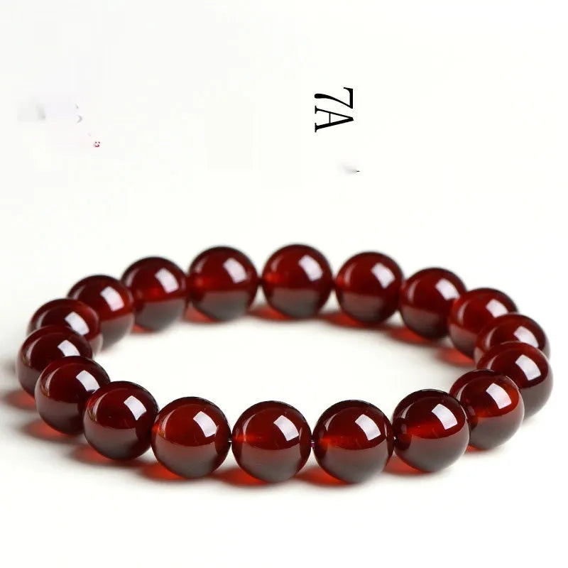 Natural orange red garnet ball crystal bracelet with traditional ruyi design elements on wrist
