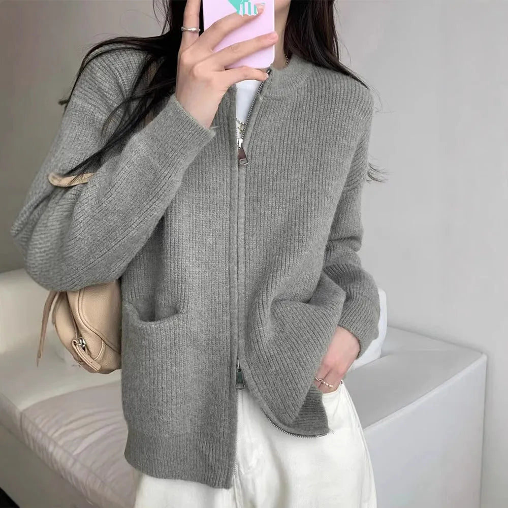 Beige women's long sleeve soft glutinous sweater coat cardigan laid flat.
