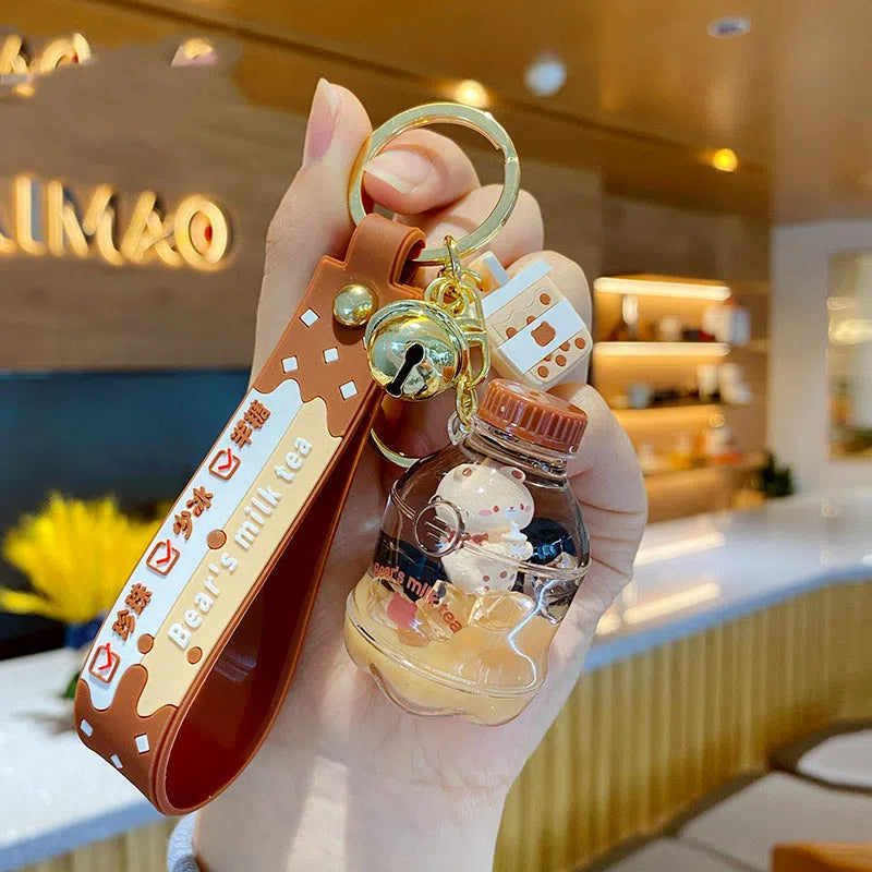 Oil-infused pearl milk tea bear keychain pendant in clear acrylic with alloy ring, featuring a drink bottle style design