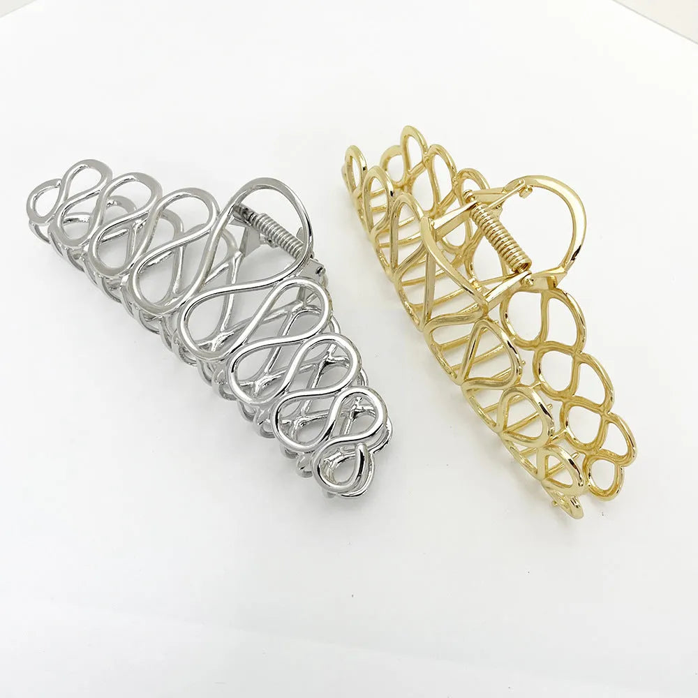 Large gold and silver hair clip with tassel accents for updo styling