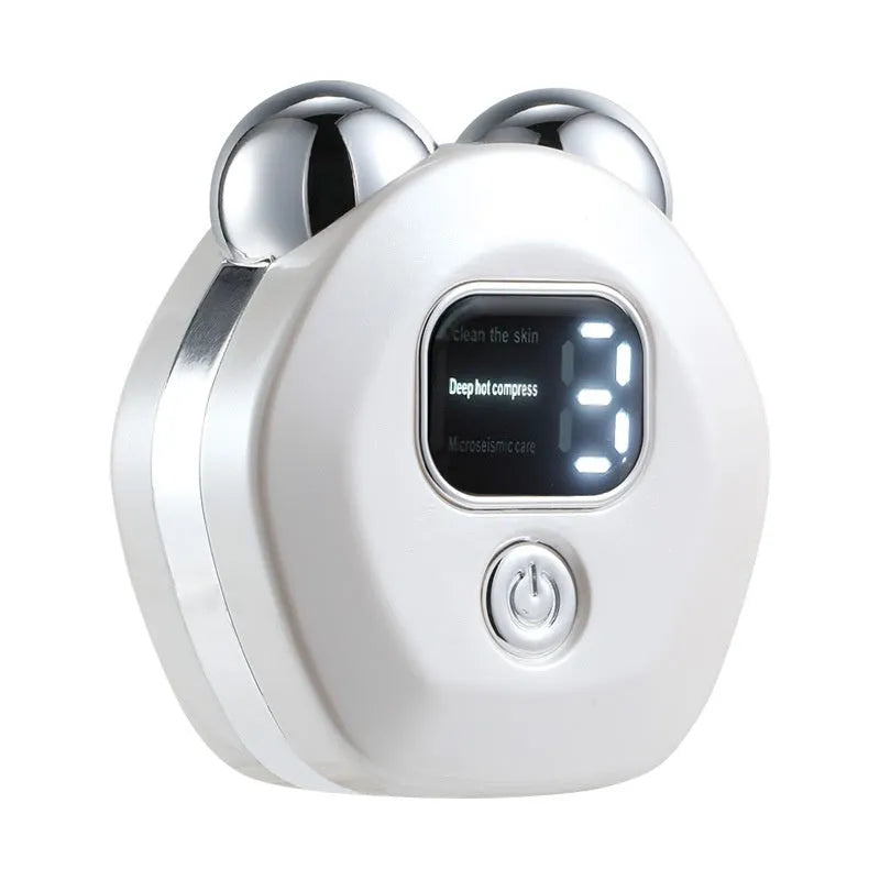Portable white hot compress micro current facial massage instrument with double-roller head on a table.
