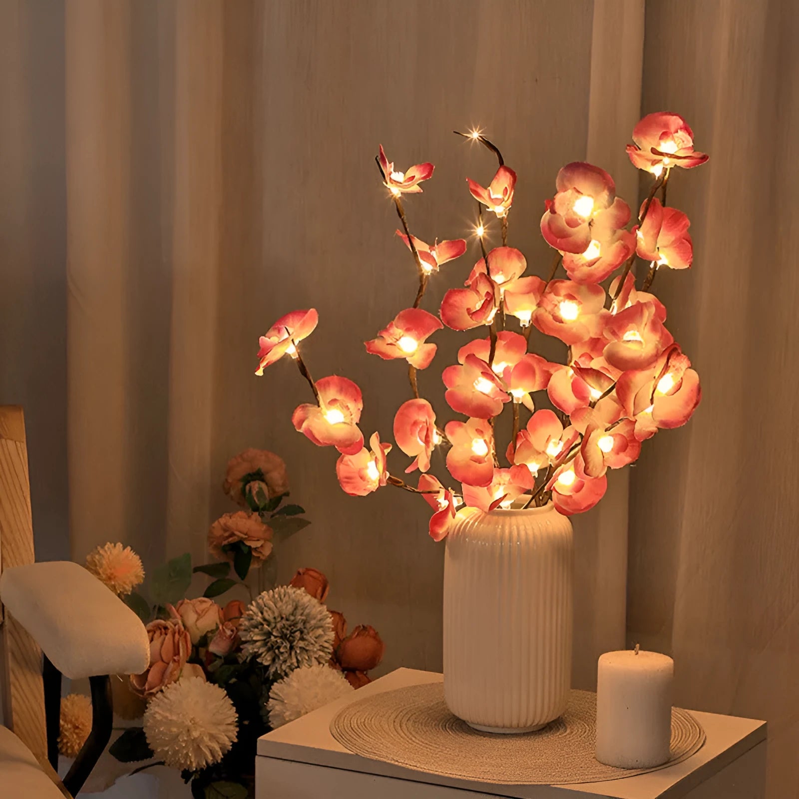 Pink LED Phalaenopsis branch decorative light on a table, 65cm long with fabric cover.