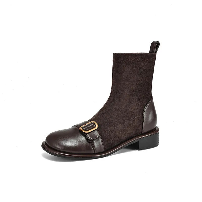 Women's black low heel lace-up Martin ankle boots with belt buckle detail on a white background.