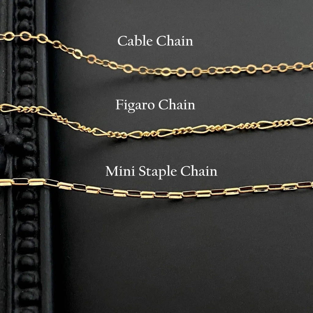 Close-up of a titanium steel ghost pendant on a stainless steel chain necklace.