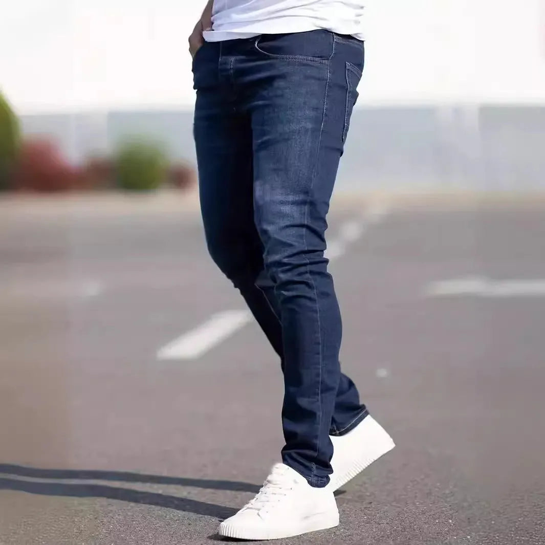 Men's dark blue slim casual jeans with street fashion styling and mid waist design