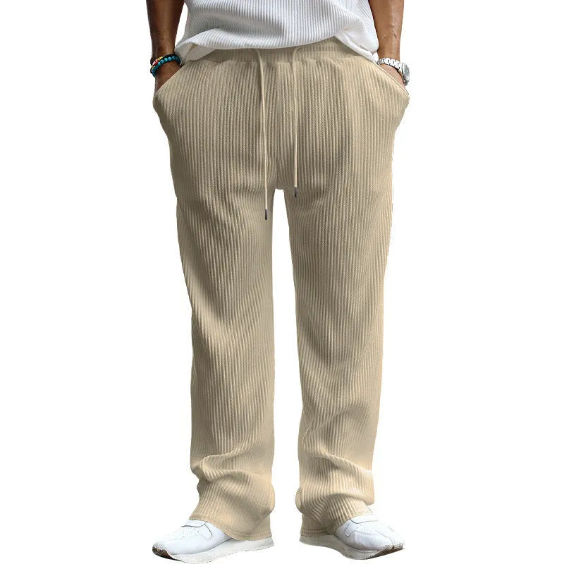 Man wearing loose high-waist striped casual trousers in Army Green, showing the straight leg fit.