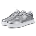 Women's white leather lace-up flat casual shoes on a solid background.