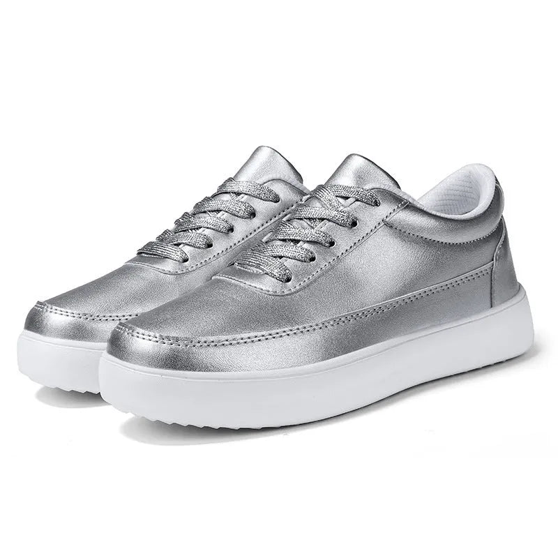Women's white leather lace-up flat casual shoes on a solid background.