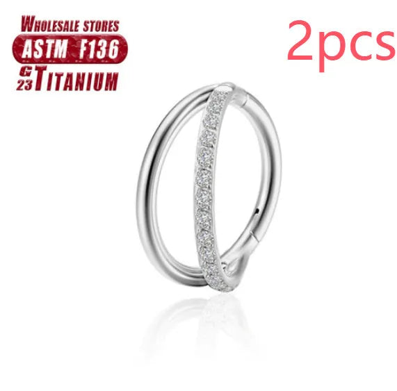 Close-up of a titanium alloy nose ring with a fork closure, shown in silver finish on a grey background.