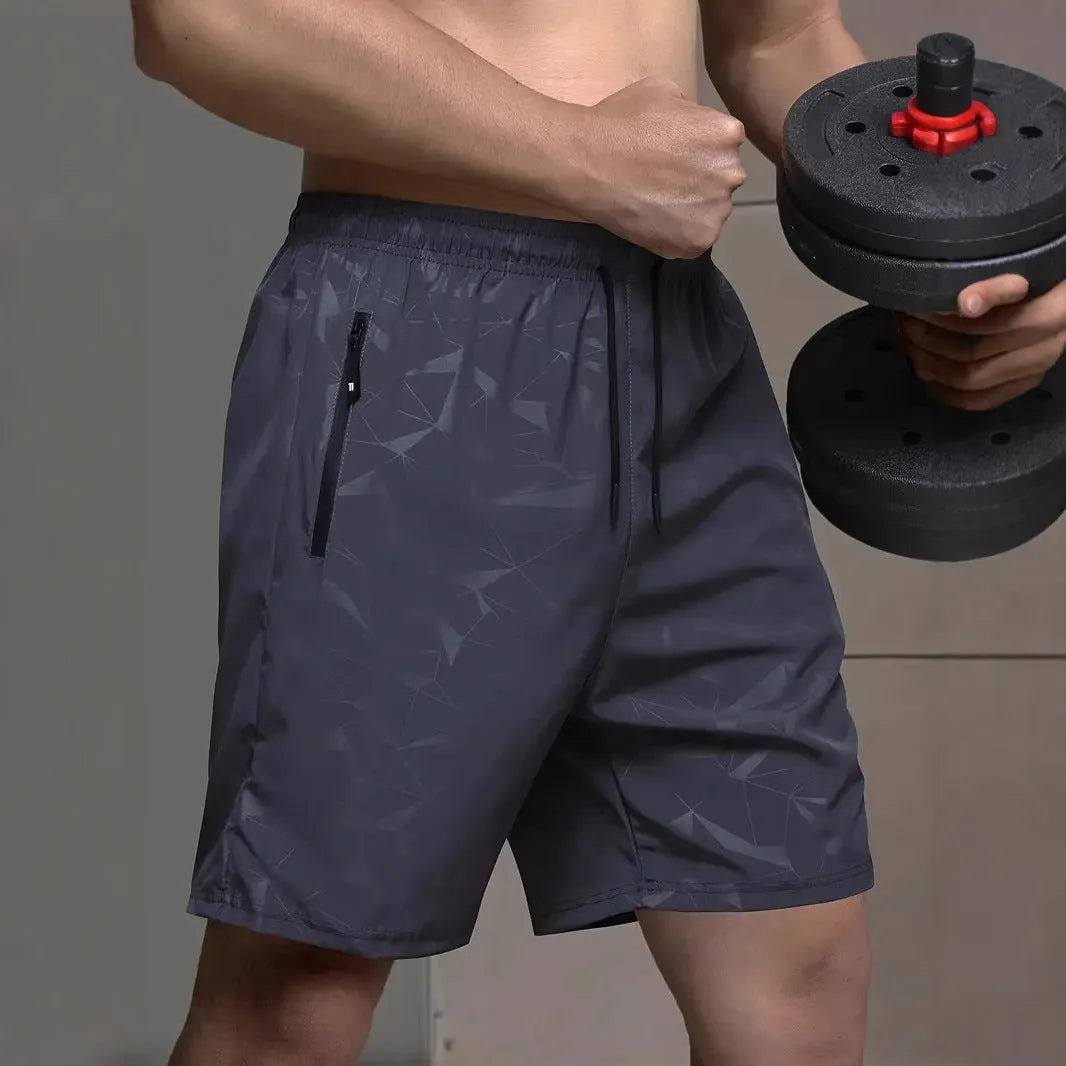 Men's loose-fit sports shorts in polyester with elastic waistband, available in black grey blue colours