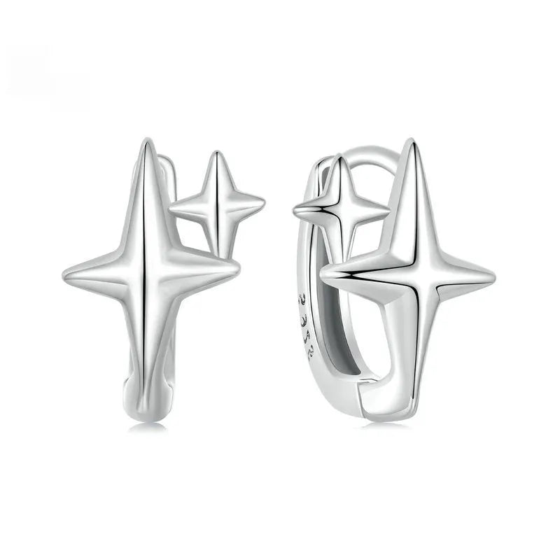 Minimalist star sterling silver ear clips with oxidation finish and XINGX design element