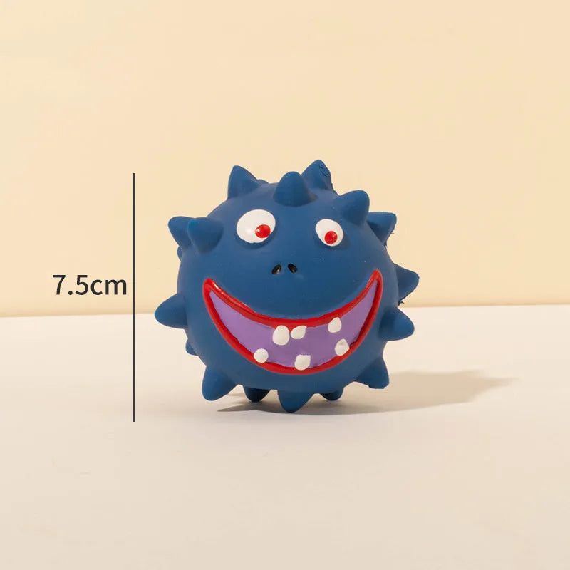 Set of four coloured latex squeaky dog balls with cute faces on a bumpy surface.