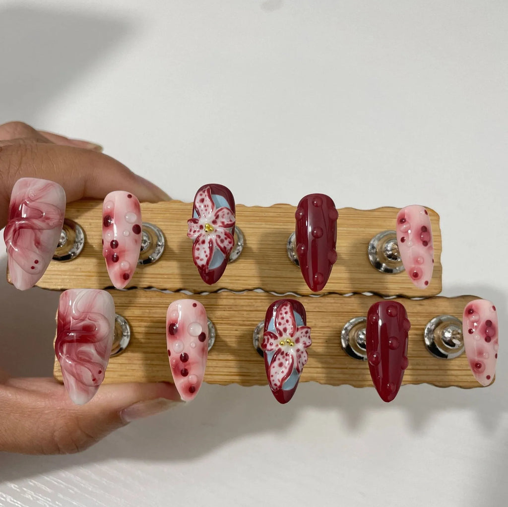 Hand-painted 3D carved manicure nails in almond colour and mid-length almond shape, showing rose and leopard print designs.