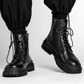 Men's mid-top black waterproof leather boots with non-slip rubber sole on flat surface