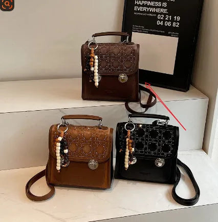 Small square PU leather messenger backpack for women with texture finish in black colour