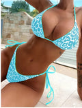 Women's lace-up front triangle bikini top with split bottoms in polyester fabric.
