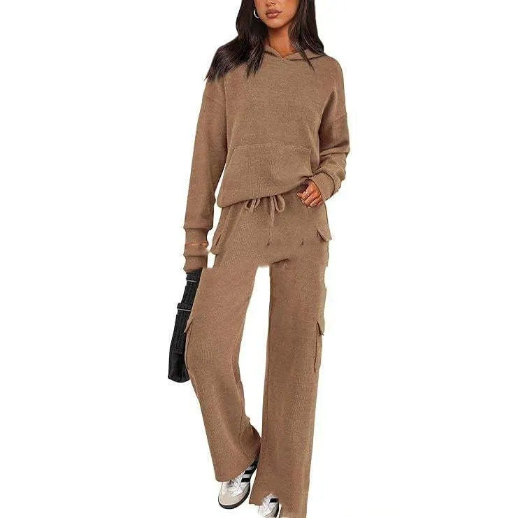 Women's black polyester leisure sports suit set with long sleeves and trousers laid flat.