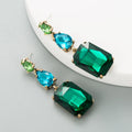 Pair of minimalist rhinestone geometric earrings in round shape, available in purple, green, or brown, European American fashion style.